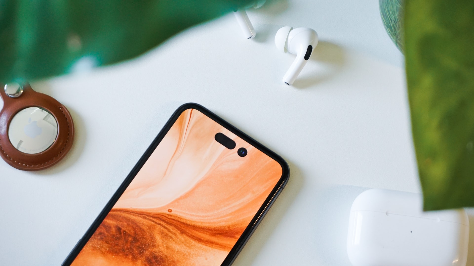 iphone on table with airpods